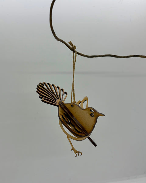 Wooden hanging decoration of a fantail bird against a white background