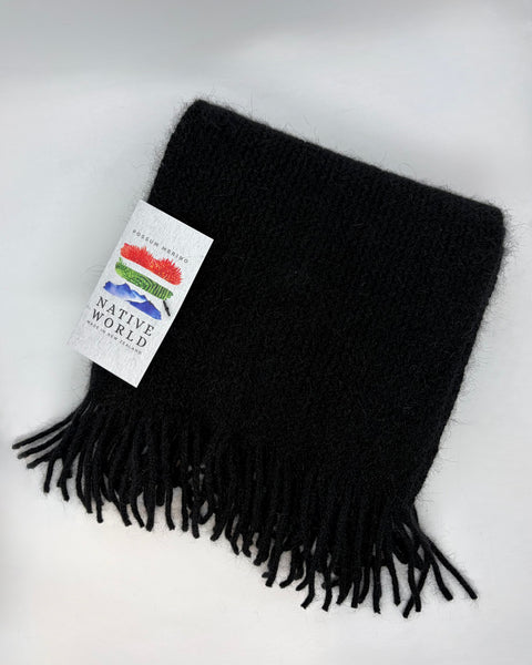 Black scarf with fringes and a 'Native World' brand tag on a white background