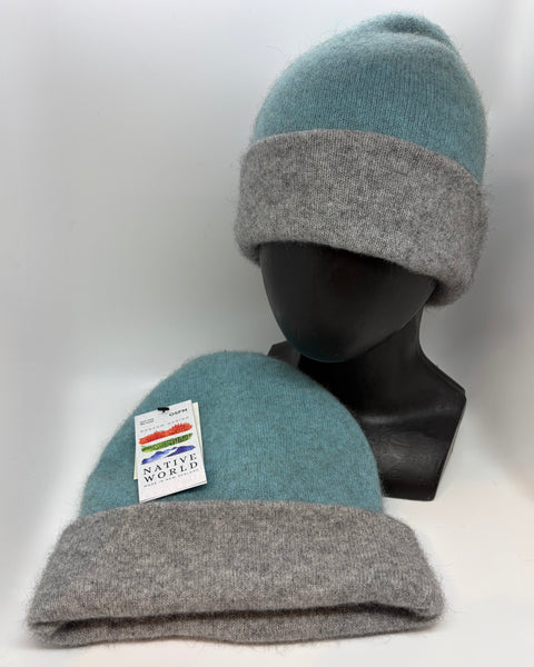 Two gray and teal beanie hats on a white background with a visible ‘Native World’ brand label.