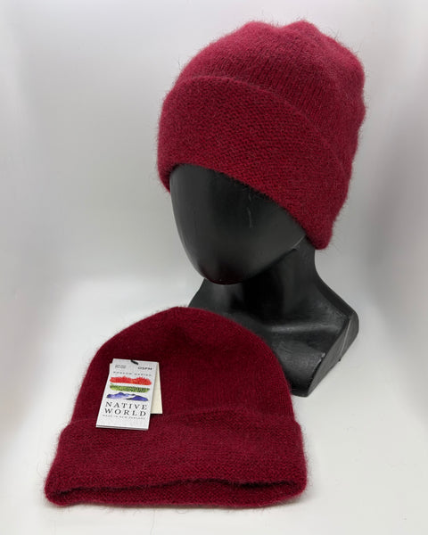 Red knit beanie on a black mannequin head with another red beanie in front on a white background