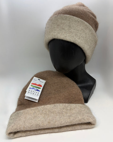Two beige and brown beanie hats on a mannequin head with a visible brand tag against a white background