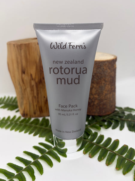 Tube of Wild Ferns Rotorua Mud Face Pack with Manuka Honey on a white background with fern leaves.