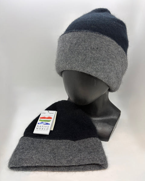 Two black and grey beanies on a mannequin head and a white background with a ‘Native World’ brand tag.