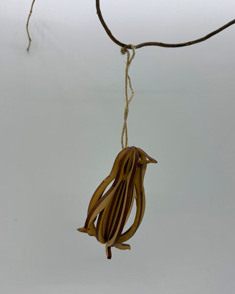 A wooden hanging decoration of a penguin