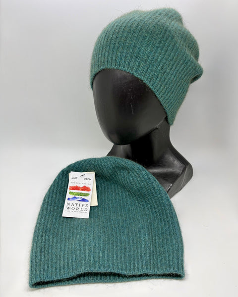 Two teal knit beanies on a mannequin head with a visible ‘Native World’ brand tag against a white background