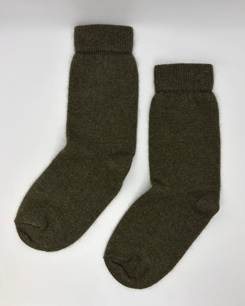 Pair of dark green socks on a white background