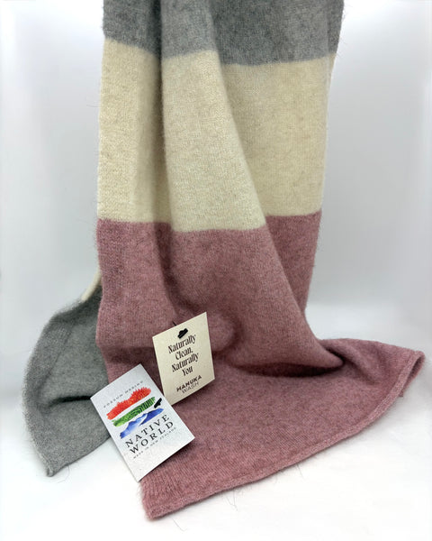 Pink, grey and cream striped knitted scarf with ‘Native World’ brand tags on a white background