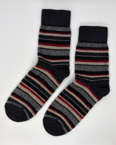 Pair of grey, red and beige striped socks on a white background