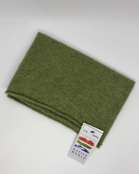 Folded green neck warmer with a ‘Native World’ tag against a white background