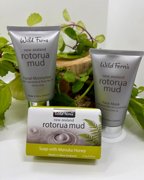 Wild Ferns New Zealand Rotorua Mud skincare products on a white surface with greenery.