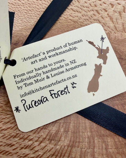 Product tag with text and a map design on a wooden surface