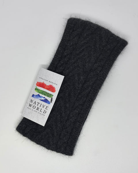 Dark grey knitted headband with a ‘Native World’ label on a white background