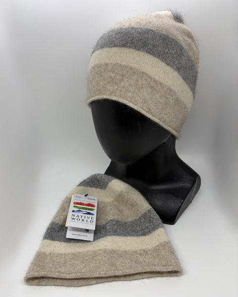 Two beige striped beanies on a mannequin head with a visible brand tag against a white background