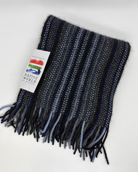 Blue knitted scarf with fringes and a visible brand label on a white background