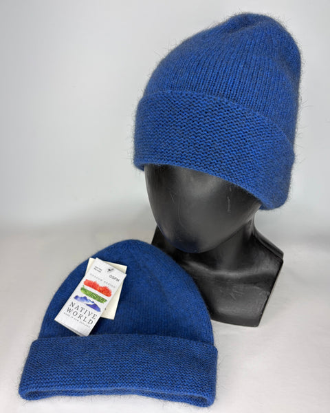 Two blue knit beanies on a mannequin head and a flat surface with a visible ‘Native World’ brand label