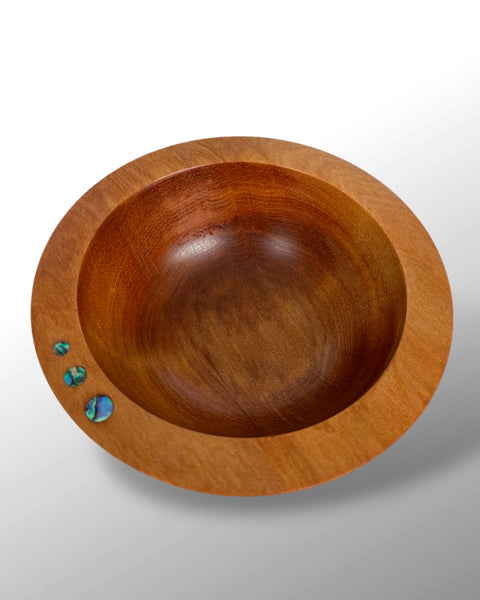 Top view of a Handcfrafted NZ Native Ancient Swamp Kauri Wood Turned Bowl with three circular Paua Shell pieces inlaid in the rim.
