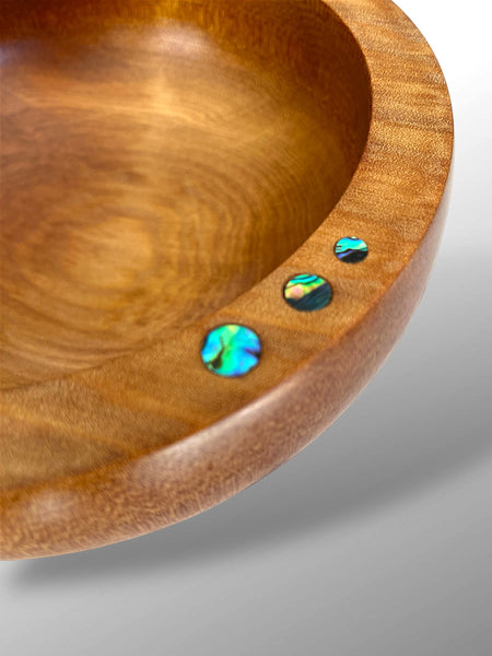Close up of the Paua Shell inlays on the rim of a Handcrafted NZ Native Ancient Swamp Kauri Wood Turned Bowl.