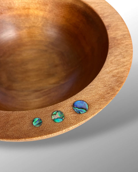 Close up of  Paua Shell Inlays on the rim of a Handcfrafted NZ Native Ancient Swamp Kauri Wood Turned Bowl 