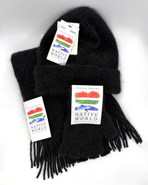 Black knit beanie, scarf and fingerless gloves set with 'Native World' tags on a white background
