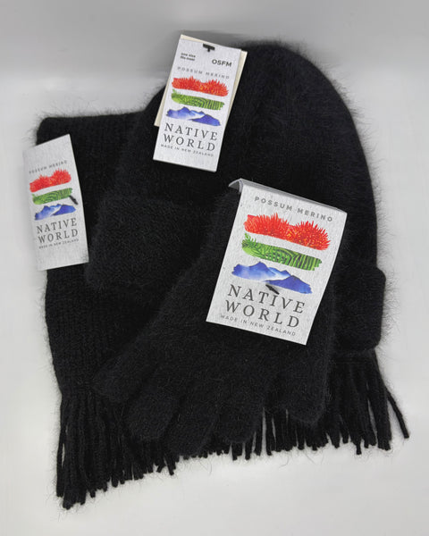 Black knit beanie, scarf and gloves set with 'Native World' tags against a white background.