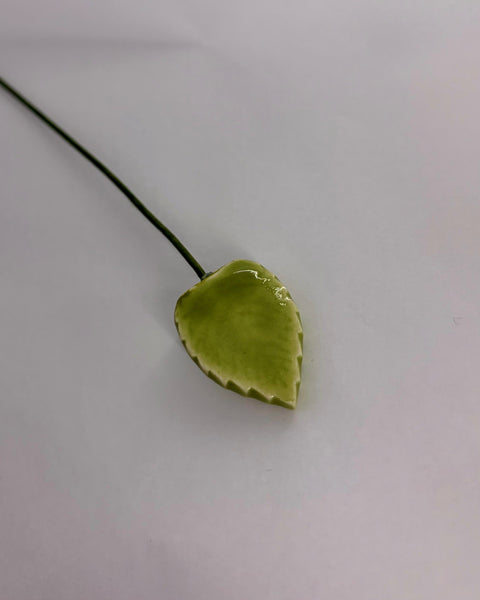 Ceramic green leaf on a thin green stem