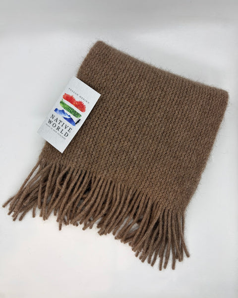 Brown knitted scarf with fringe and a ‘Native World’ brand label on a white background