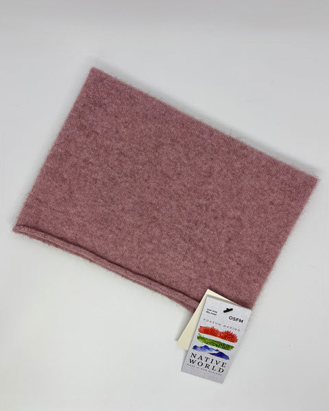 Pink knitted neck warmer with a ‘Native World’ tag on a white background.
