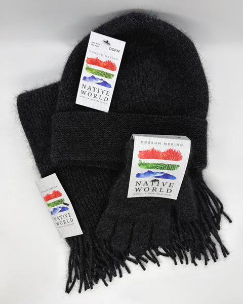 Dark grey knitted beanie, scarf and gloves set with 'Native World' tags against a white background.