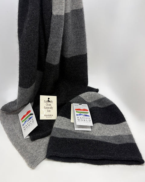 Grey and black striped beanie and scarf set with 'Native World' tags on a white background