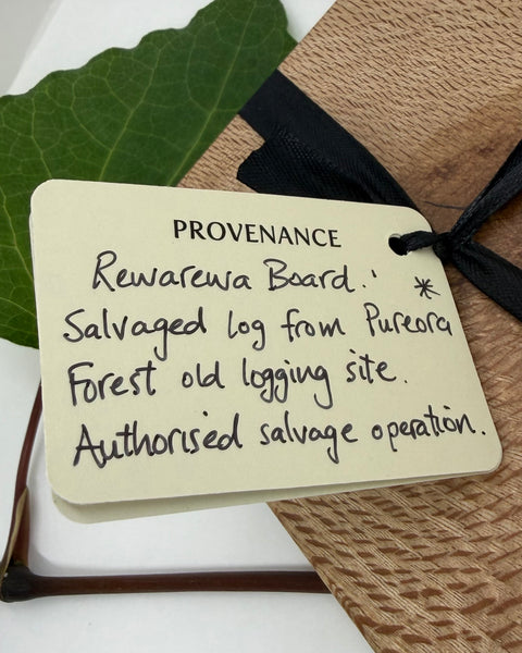 Provenance label on a wooden board with text about logging history.