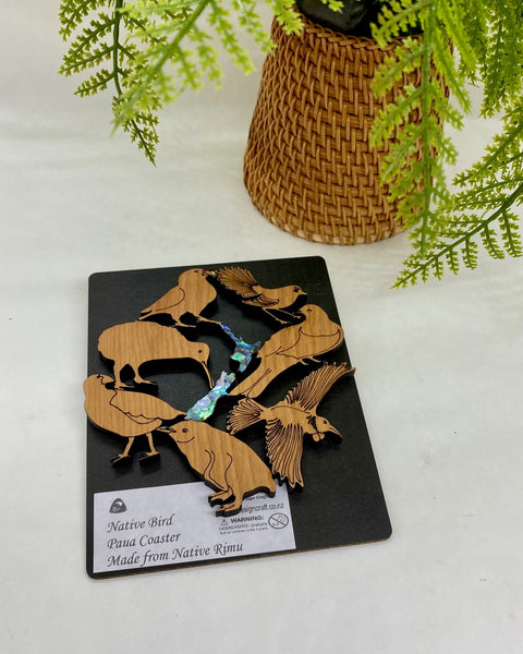 Set of wooden bird coasters on a black card.