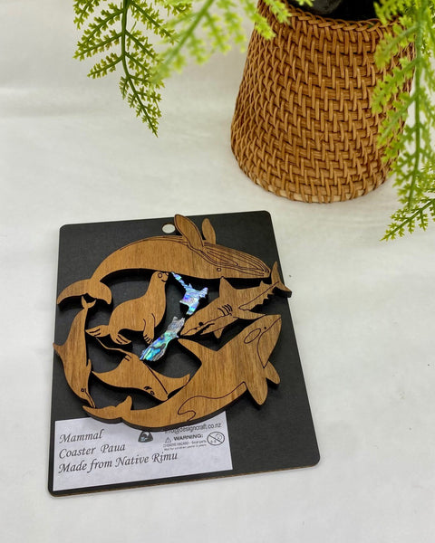 Wooden coaster with animal design on a black card.
