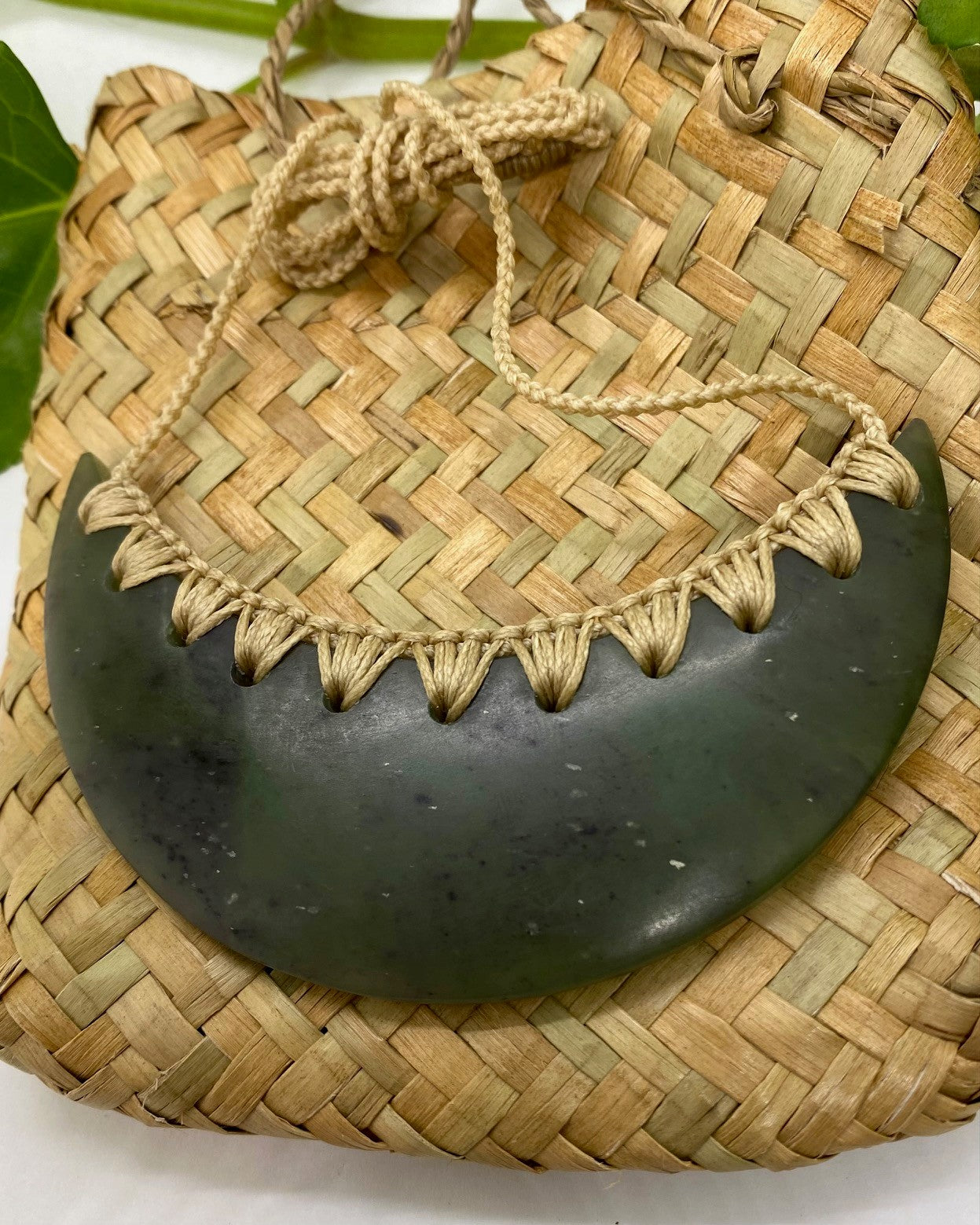 Greenstone Breastplate necklace with woven neck cord on a woven flax cord