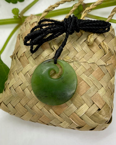 Greenstone Disc pendant with spiral koru and black woven neck cord