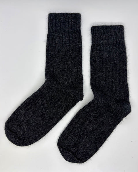 Pair of dark grey socks on a white background