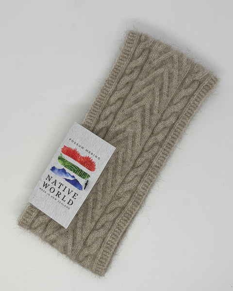 Beige knotted headband with a ‘Native World’ brand label on a white background