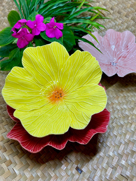 Three colourful ceramic flower-shaped bowls
