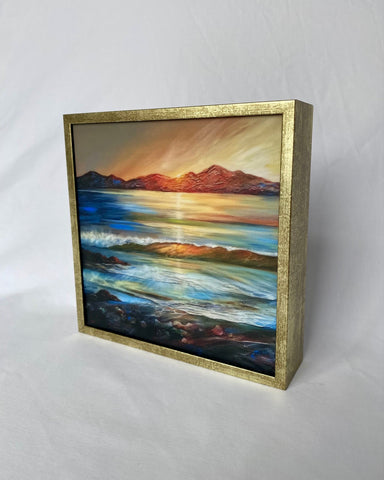 Framed painting of a landscape with mountains and water on a white background