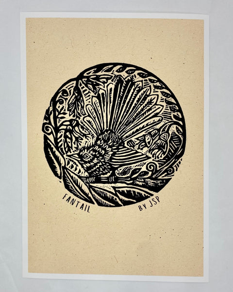 A black Illustration of a fantail on a branch amongst the leaves on beige art paper.