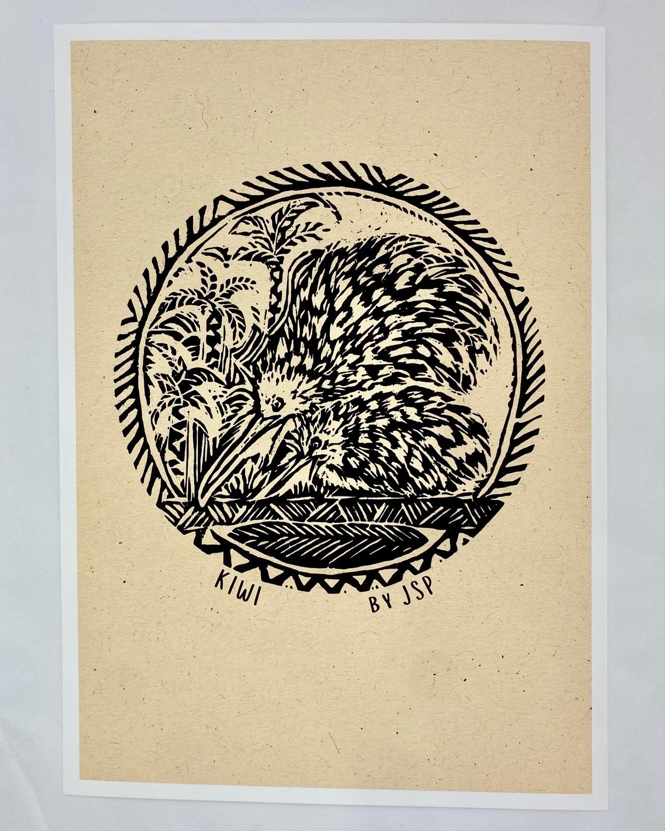 A black illustration of two kiwi birds n beige art paper.