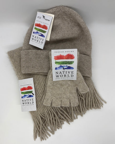 Beige knit hat, scarf, and gloves set with 'Native World' tags on a white background