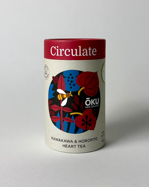 A cylindrical container of OKU loose leaf tea labeled 'Circulate' with a illustration of herbs and a bee on the front.