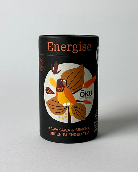 A package of OKU Energise tea bags with a black label featuring a bird and leaves design, and text indicating the blend of Kawakawa and Sencha green tea.