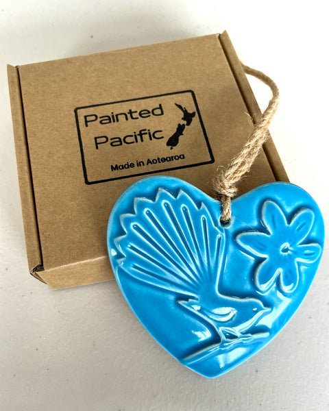 A Ceramic Light Hanging Heart with a fantail design, twine loop for wall display and a gift box. Made in Aotearoa New Zealand by Painted Pacific Pottery.