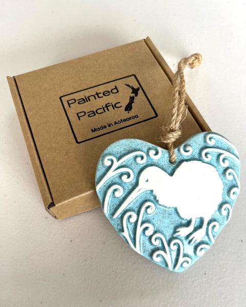 A Blue Ceramic Heart with a Kiwi and Koru design, with a twine loop for hanging and its own gift box. Made in New Zealand by Painted Pacific Pottery