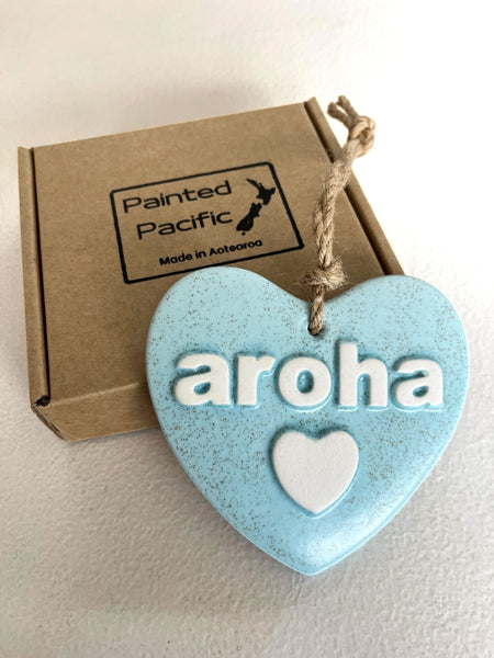 Light Blue Ceramic Heart with the word Aroha, meaning love. With a twine loop for hanging and its own gift box. Made in New Zealand by Painted Pacific Pottery