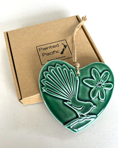 A Ceramic Green Hanging Heart with a fantail design, twine loop for wall display and gift box. Made in Aotearoa New Zealand by Painted Pacific Pottery.