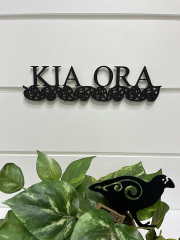 A NZ made 'kia ora' welcome wall sign in balsa wood and finished in black
