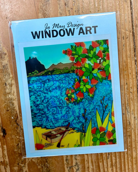 Window art decal with rowboat on the beach on a wooden surface