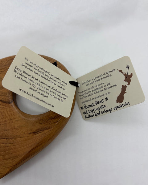 Product information labels on a wooden kitchen utensil.